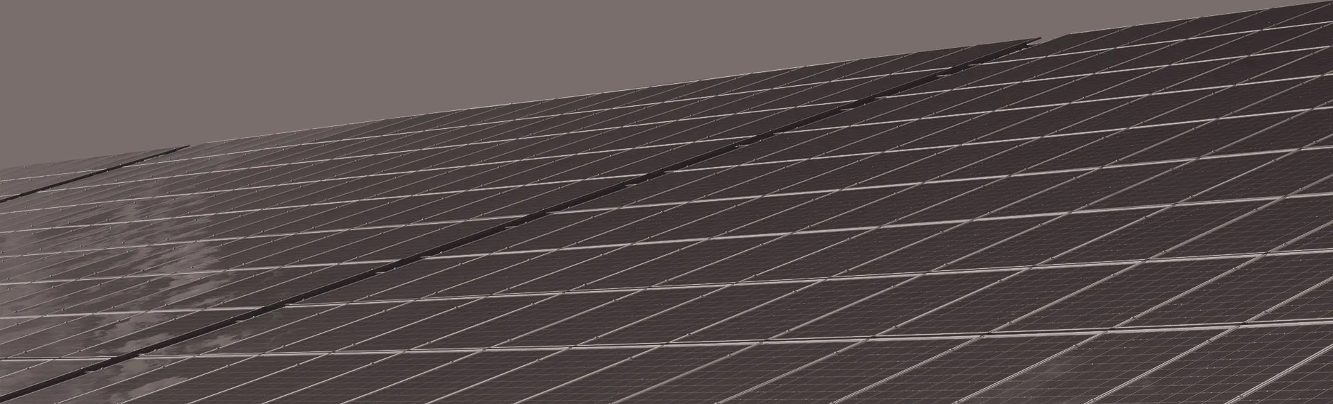 A dark image of solar panels in a row